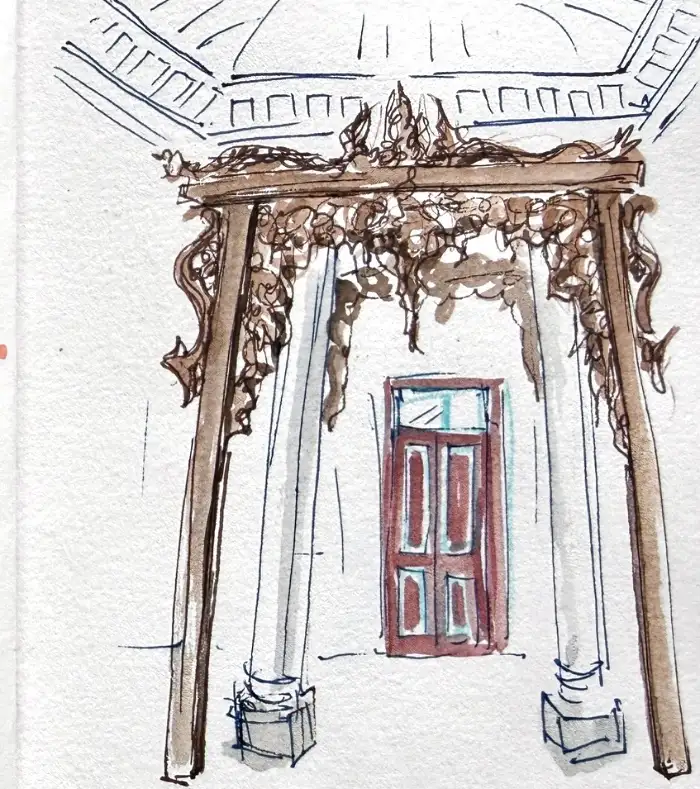 A dark teak arch drawn in fine pen, carved all over, framing a plain red door