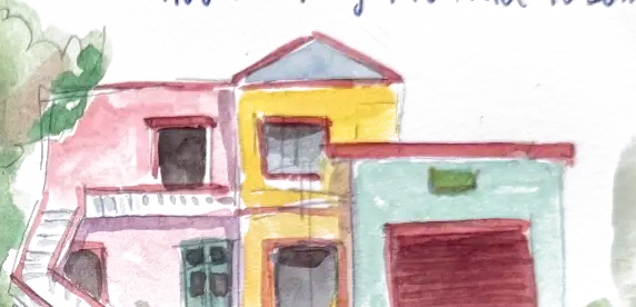 A pink and yellow house with a teal garage door and a white outside staircase