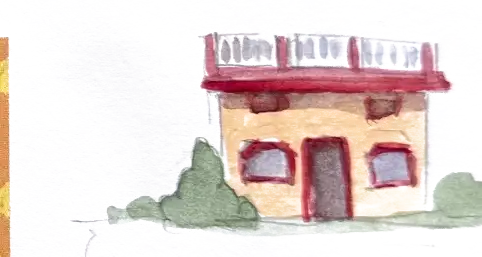 A small ochre house with a red roof rail and red window frames