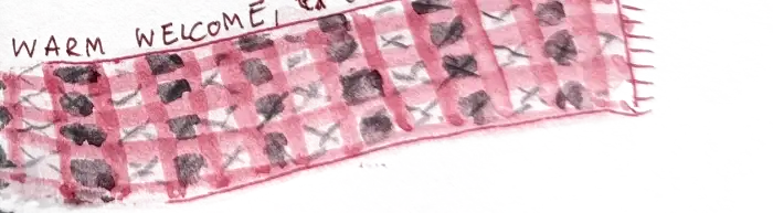 A khata scarf painted in red and white check, the words warm welcome, experience of Nepal written along the top