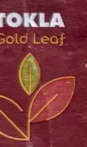 A small maroon tea tag, Tokla Gold Leaf, with a gold leaf drawn on it