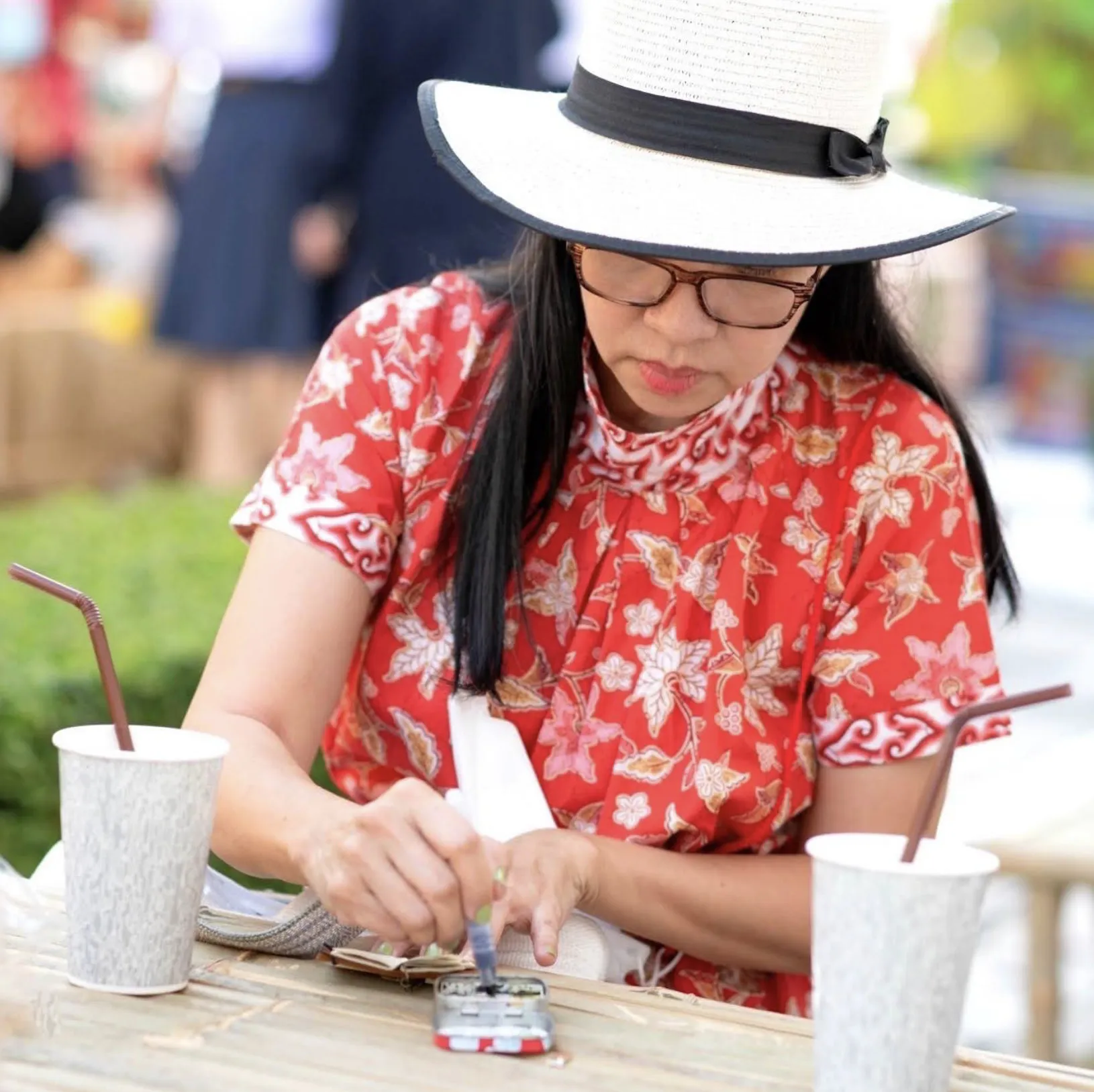 Gift Kitiya painting a miniature on location
