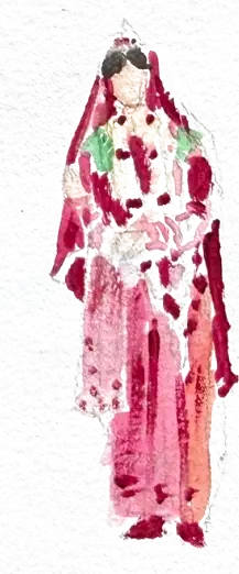A bride standing very straight in deep pink and red, gold at her throat and a red veil over her hair