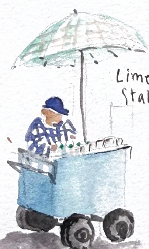 A lime juice stall: a blue cart on fat wheels under a checked green parasol, the vendor in a navy hat behind it